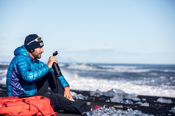 Outdoor-Abenteuer trinkt aus Thermos-Flasche