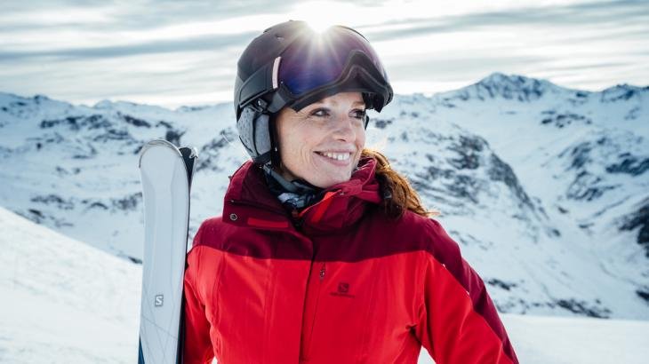 Woman standing on piste with Salomon equipment