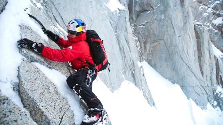 David Lama an einer verschneiten Bergwand.