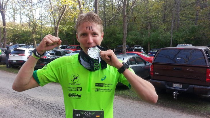 Charles Franzke mit Medaille in Siegerpose.