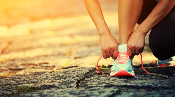 Woman ties bow in running shoe